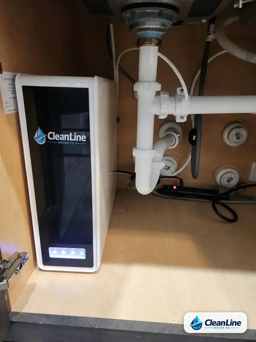 CleanLine Water Co. tankless reverse osmosis drinking water system installed inside a kitchen sink cabinet in a Central Texas home